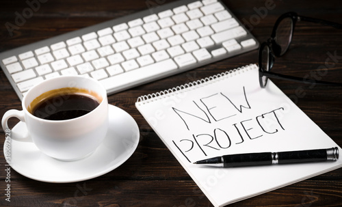 office desk with laptop  notebooks and coffee cup on wooden background.