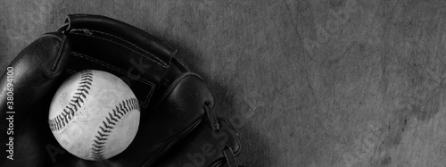 Photography baseball and glove on old wood background in black and white.