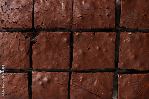 Chocolate brownie as background. Top view.