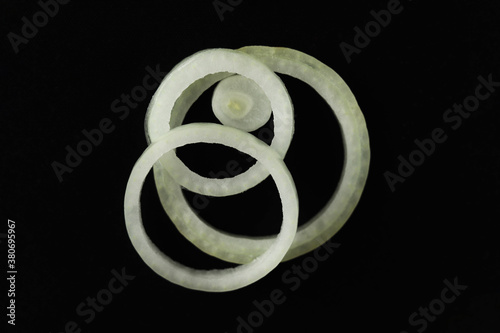 Cut onion rings on a black background