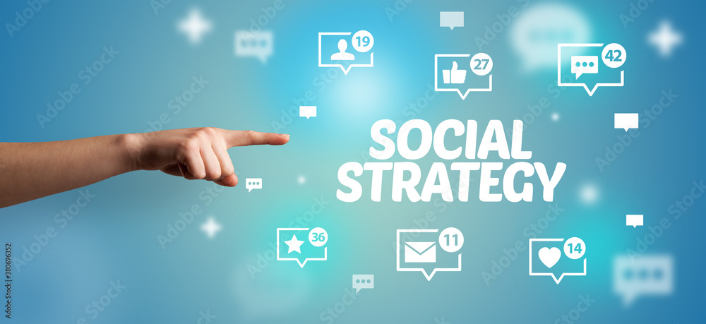 Close-Up of cropped hand pointing at SOCIAL STRATEGY inscription, social networking concept Close-Up of cropped hand pointing at SOCIAL STRATEGY inscription, social networking concept
