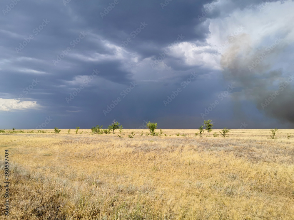 stormy sky in the field, thunderstorm in the steppe, fire in the steppe