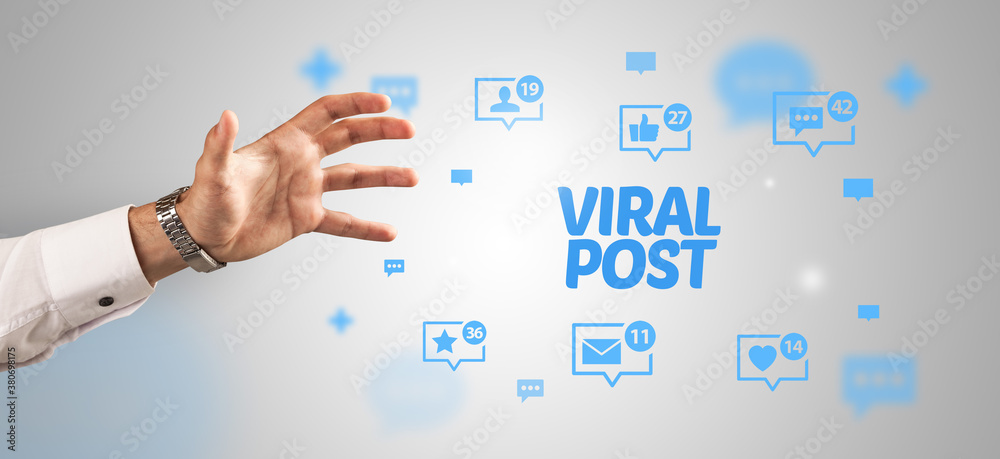 Close-Up of cropped hand pointing at VIRAL POST inscription, social networking concept Close-Up of cropped hand pointing at VIRAL POST inscription, social networking concept