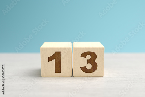 Wooden toy blocks forming the number 13.