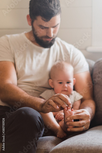 Father counting baby toes photo