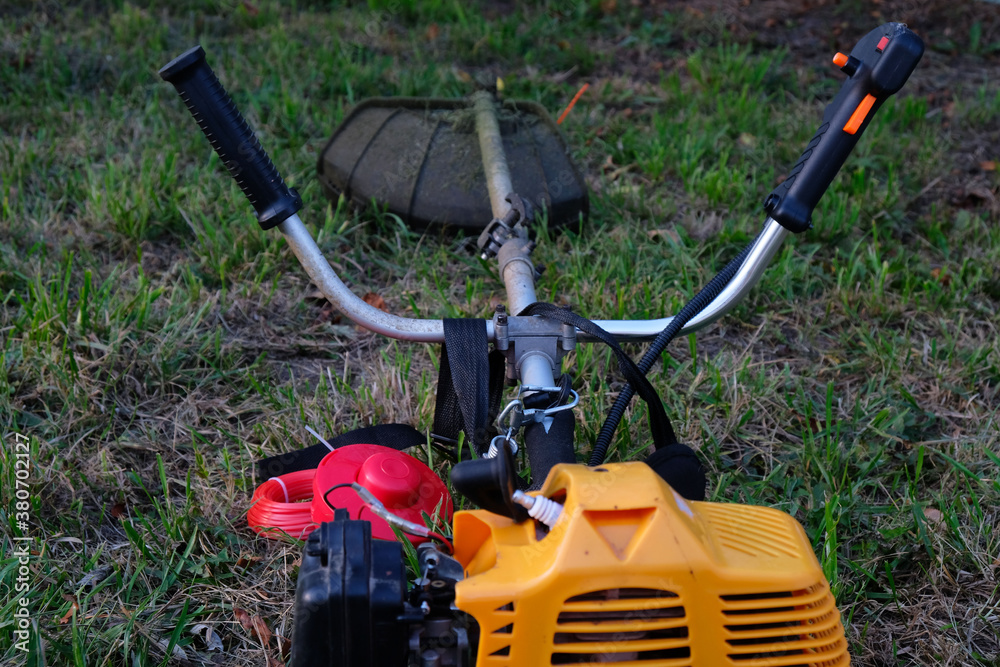 grass trimmer on the background of the lawn grass trimmer on the background of the lawn