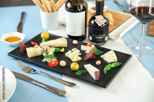Assorted spanish cheese platter with red wine