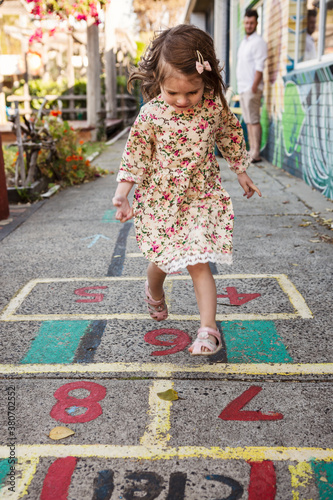 Girl playing hopscotch