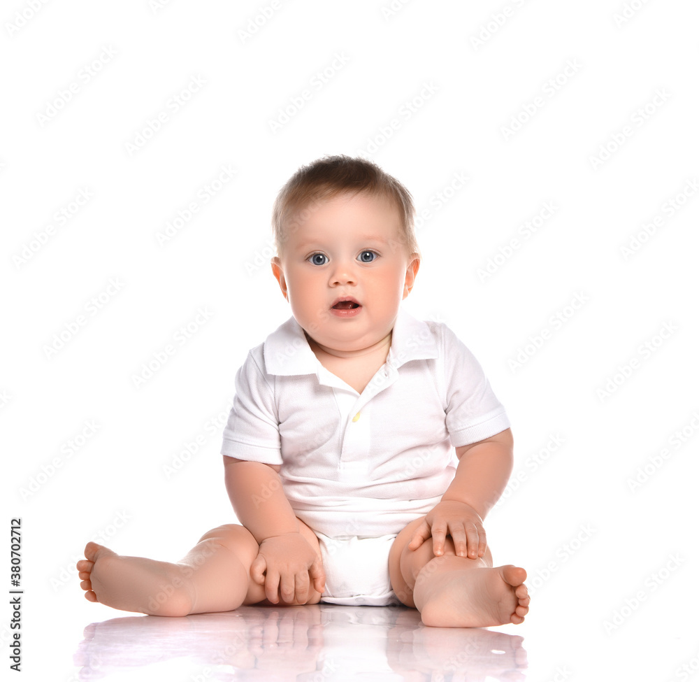 Portrait of a concerned child sitting in the studio on a white background. Portrait of a concerned child sitting in the studio on a white background.