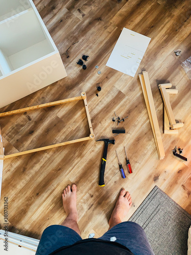 Man Assembling Furniture With Instructions photo