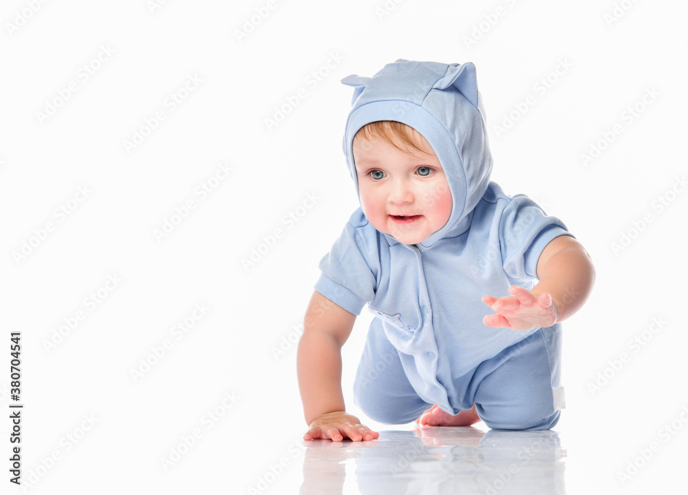 Baby wearing funny suit crawling on studio floor Baby wearing funny suit crawling on studio floor