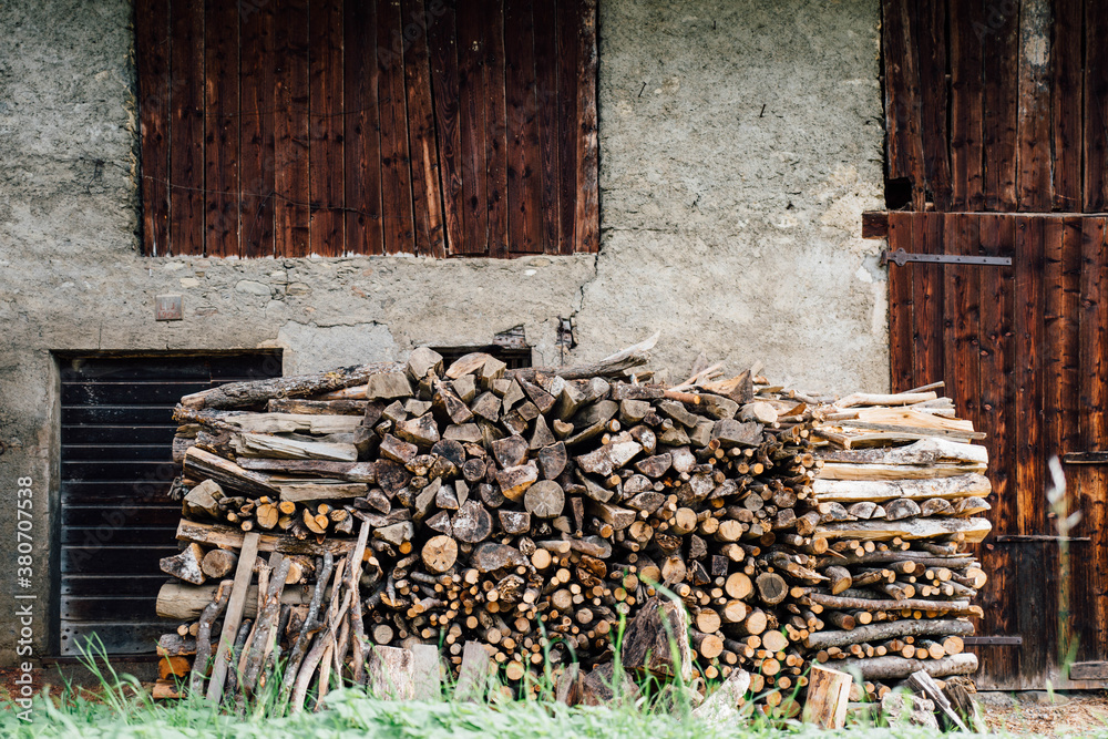 Wood stacked outside a rustic alpine barn. Wood stacked outside a rustic alpine barn.