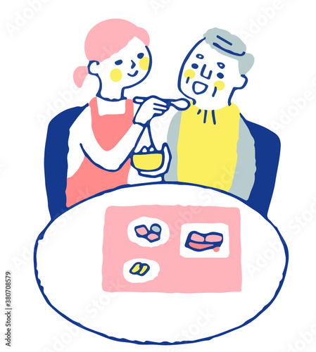 食事の介助をする女性とシニア男性
