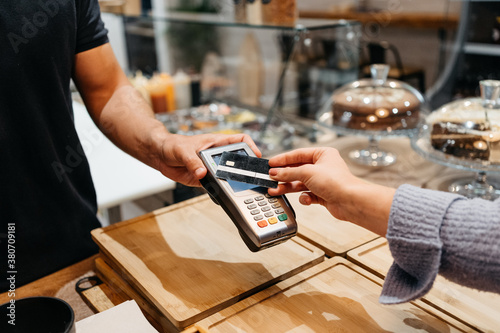 Detail of a client hands paying with the credit card at a restaurant photo