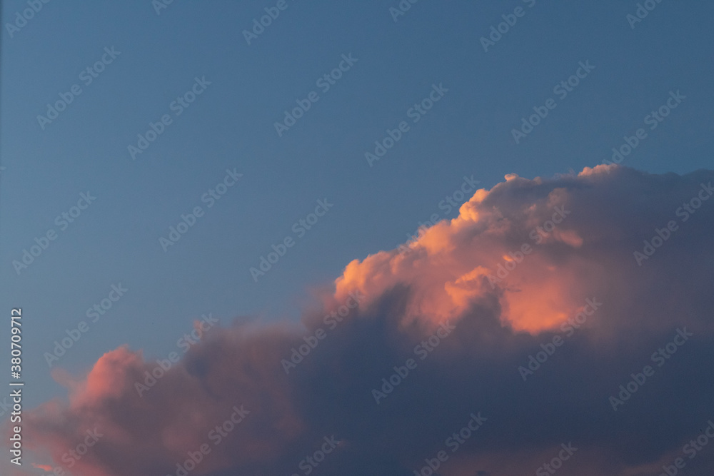 Colorful clouds at sunset in blue sky.