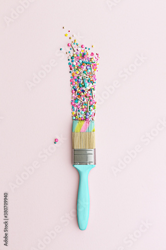 Paintbrush and colorful cake sprinkles photo
