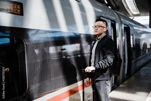 Businessman waiting for train at train station