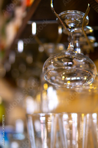 glasses hanging over the bar on a blurred background glasses and glasses. copy space