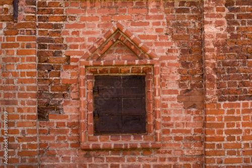 Window in the wall of an old brick house