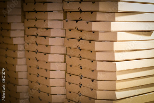 many paper pizza packs lie on top of each other. background. copy space