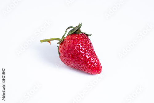 Aerial view of single strawberries on white background