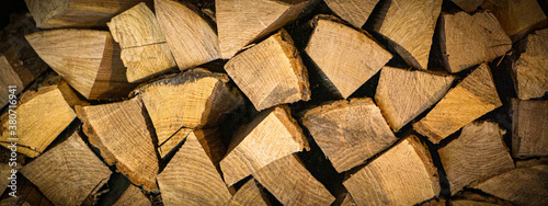 stacked light firewood as a background with dark vignetting at the edges