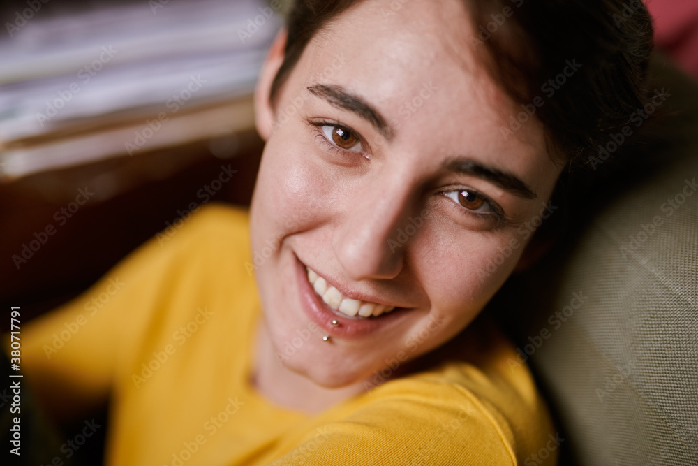 Girl sitting on floor and smiling at camera Girl sitting on floor and smiling at camera