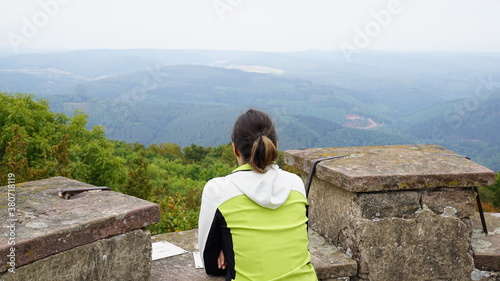 a woman enjoying the view from the observation tower in the Odenwald in the region Baden-Wuerttemberg in Germany, September