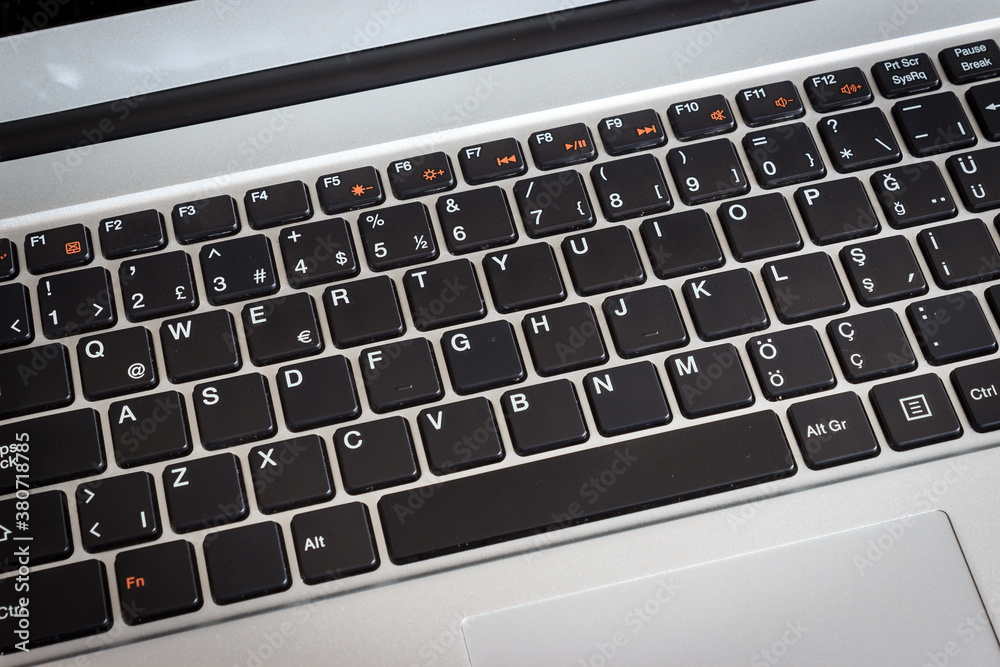Close up laptop keyboard. Black keys on grey laptop. Technology concept. Close up laptop keyboard. Black keys on grey laptop. Technology concept.