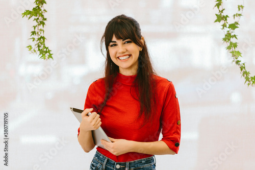 Smiling female employee with tablet