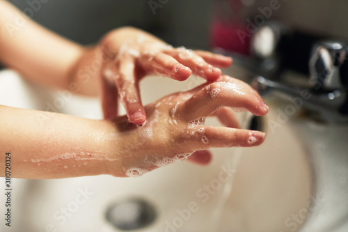 Child washing their hands photo