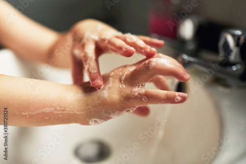 Child washing their hands