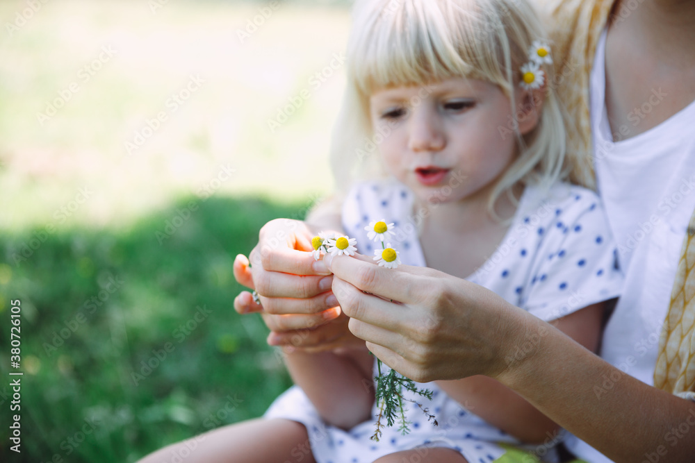 Happy mother and daughter outdoors with flowers Happy mother and daughter outdoors with flowers