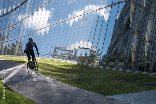Urban cyclist in rides in modern city