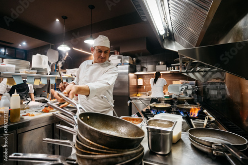 Professional chef cooking in restaurant kitchen