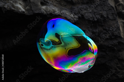 Weirdly shaped soap bubble in front of volcanic rocks
