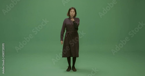 Studio, slow motion, green screen, a female lecturer silences a member of the audience, London, UK photo