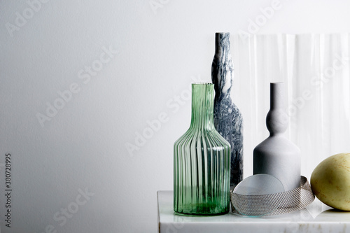 Clean and crisp still life of marble and glass ornaments on marble table top photo