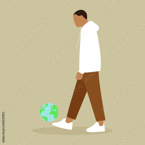 A man kicks the globe like a ball