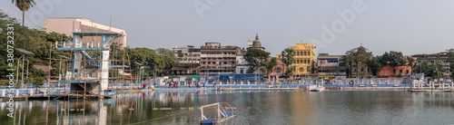 Kolkata, India - February 2, 2020: Panoramic view over a water park with diving tower and a water polo goal with unidentified people in the background on February 2, 2020 in Kolkata, India