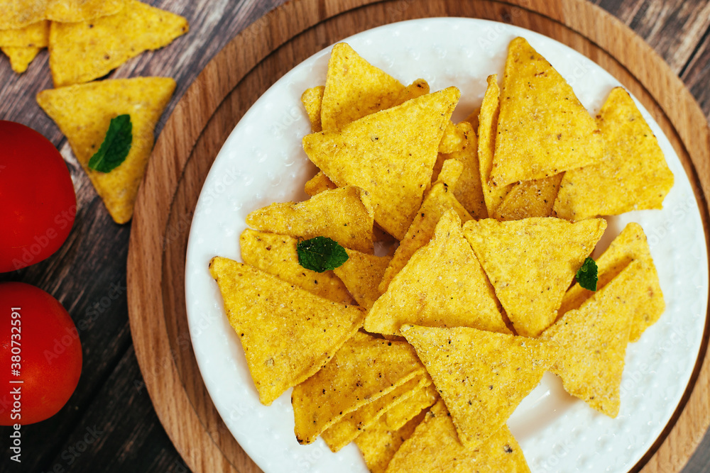 tortilla chips in a white bowl with tomato dip on a wooden table tortilla chips in a white bowl with tomato dip on a wooden table