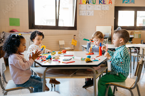 Diverse kids playing with modeling clay