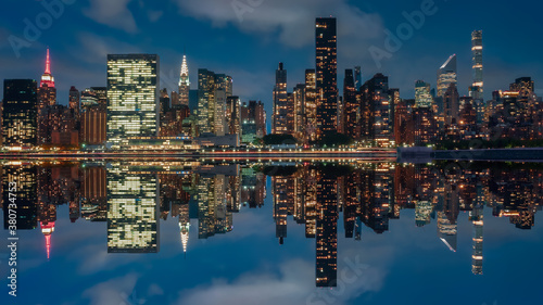View of the skyline of Manhattan, New York, USA, at night, from the Dumbo area. Photography, reflection effect