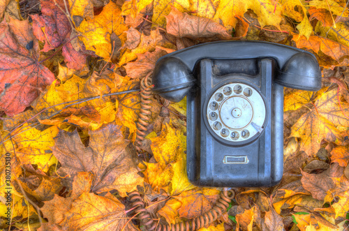 old broken phone on the autumn street HDR