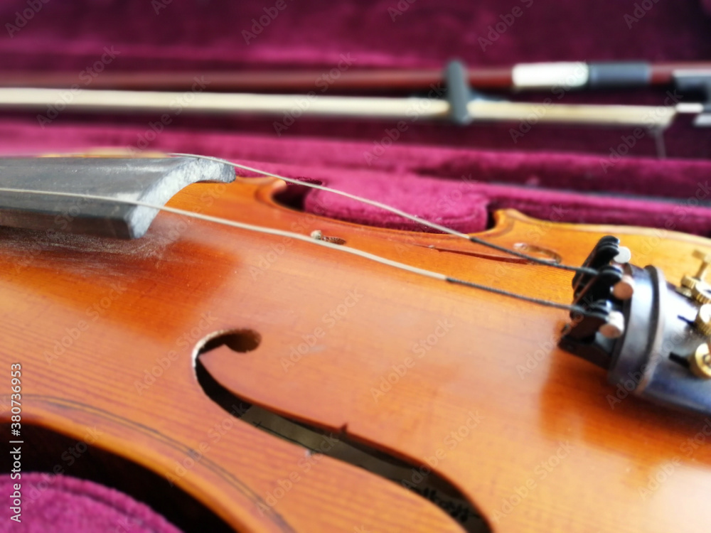 Violin and bow in dark red case. Close up Violin and bow in dark red case. Close up