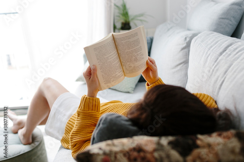 Back of woman reading on the sofa