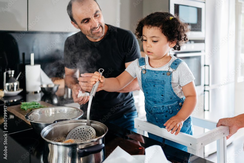 Happy family cooking vegan food at home Happy family cooking vegan food at home