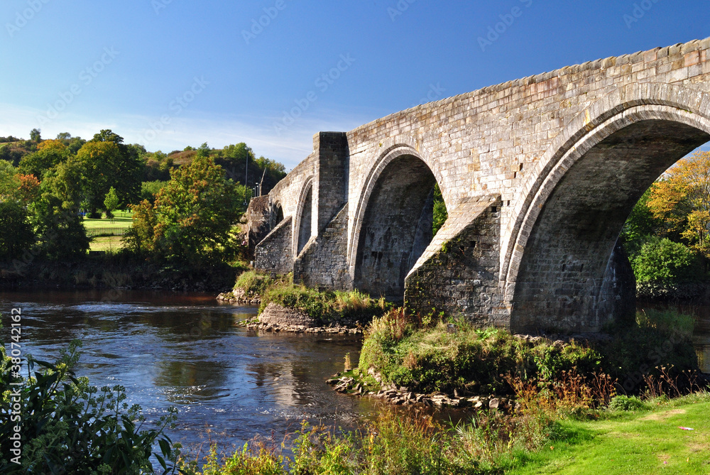 View of Old Stone Bridge over River on Sunny Day