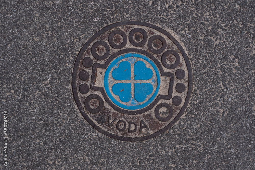 Water line cover on a street with beautiful hearts design and text Water line cover on a street with beautiful hearts design and text