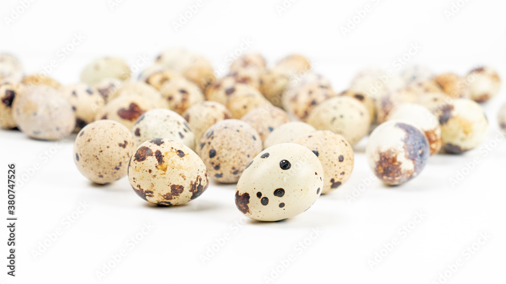 Raw quail eggs on a white background